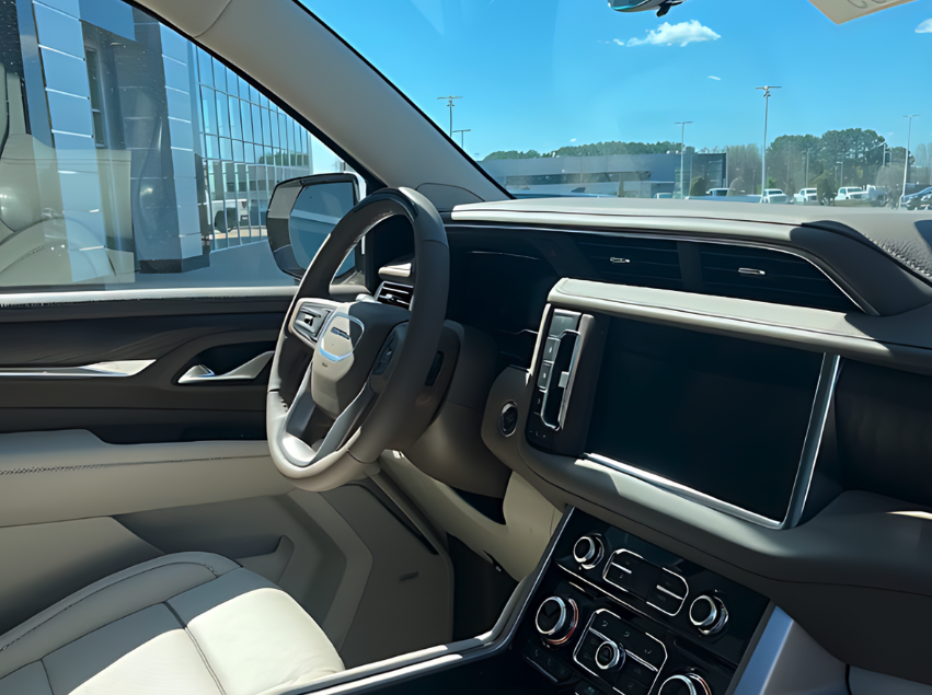 Interior view of a GMC SUV showing the steering wheel, dashboard, and touchscreen at Crain Buick GMC in Conway, Arkansas